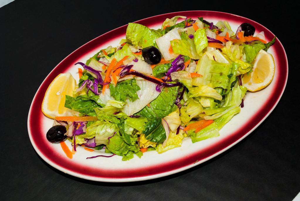 Green Salad · Largely chopped romaine, red leaf and green leaf lettuce, grated red cabbage and carrots dressed with lemon juice.