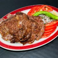 Doner Kebab · Ground lamb is wrapped around a large vertical spit and grilled in front of an ingenious tie...