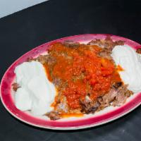Iskender Kebab · Gyro kebab in a lightly hot tomato sauce over toasted pide. Served with hot yogurt sauce.