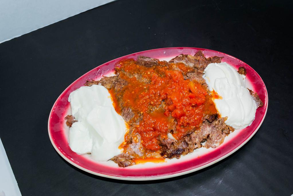 Iskender Kebab · Gyro kebab in a lightly hot tomato sauce over toasted pide. Served with hot yogurt sauce.