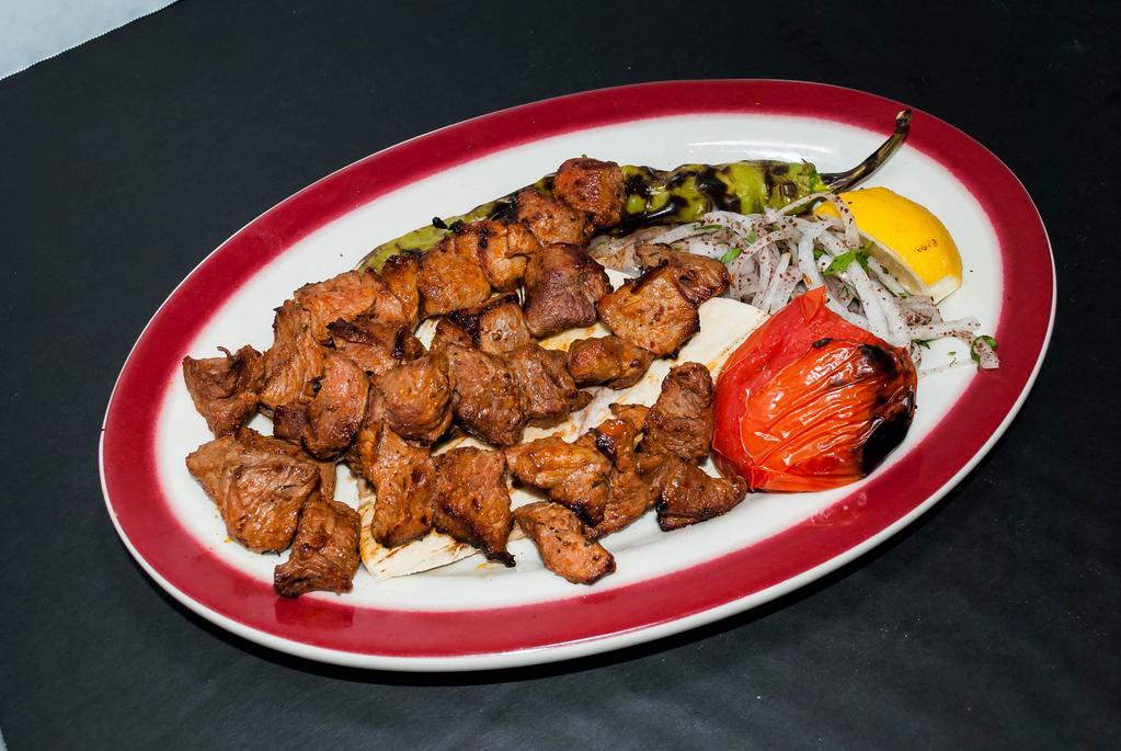 Diced Shish Kebab · Small cubes of baby lamb marinated in the chef's special sauce and grilled on skewers with onions, salad, roasted peppers and tomatoes served with rice or french fries.