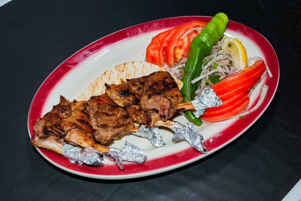 Lamb Chops · Baby lamb chops grilled to your taste served with green peppers and tomatoes with rice or french fries.