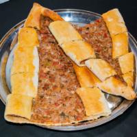 Kiymali Pide · Thin crust topped with a blend of ground lamb, tomatoes, onions, parsley, black pepper and p...
