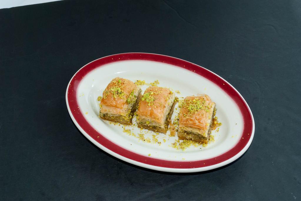 Baklava · Layers of very thin fillo dough layered with walnuts and pistachios then baked until golden and served with honey syrup.