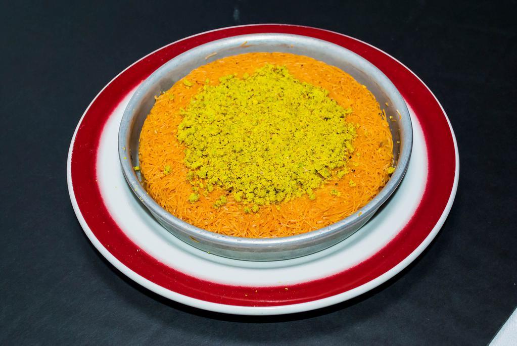 Kunefe · Shredded dough layered with sweet kunefe cheese, baked to a golden color and served with honey syrup and pistachio topping. Specially made for each order it takes approximately 10 minutes to prepare.