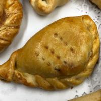 Chicken Empanada · Pollo. A special pastry dough filled with ground chicken, a slice of hard boiled egg, scalli...