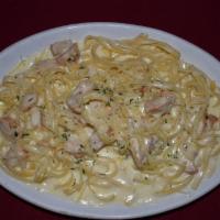 Fettuccine Alfredo · Fettuccine pasta with creamy alfredo sauce. Served with side salad and bread.