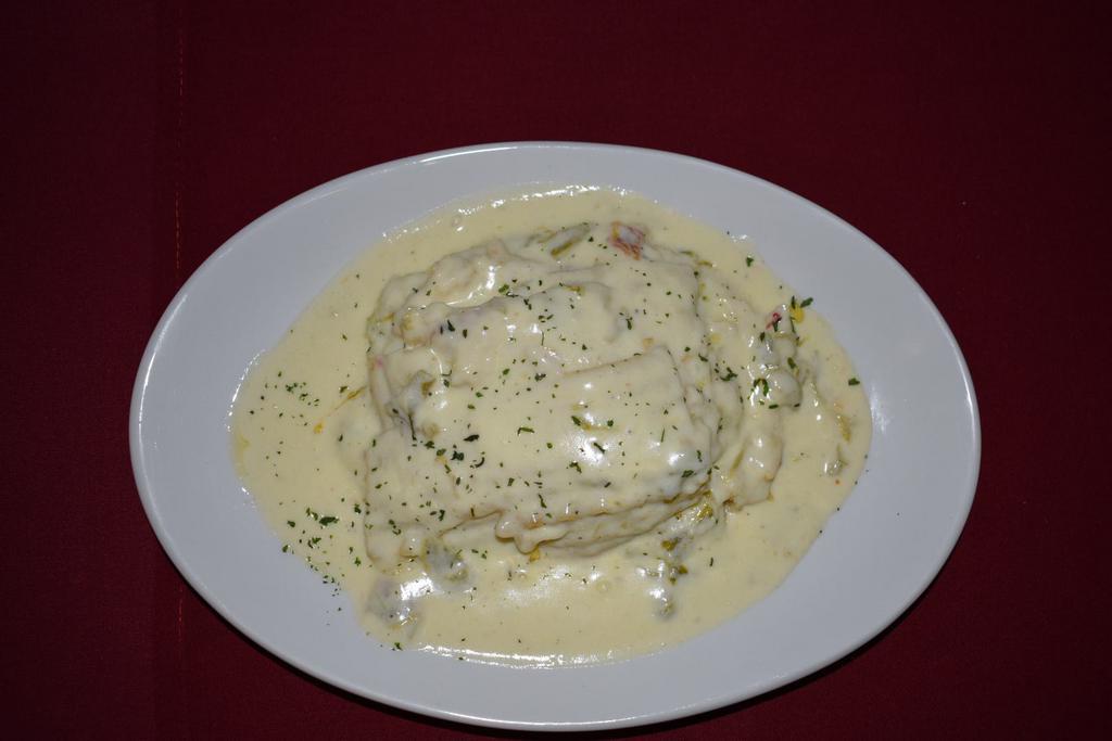 Green Chile Chicken Lasagna  · Homemade green chile chicken lasagna with layers of pasta, mozzarella and parmesan cheeses, chicken, baked in a hatch green chile alfredo sauce. Served with side salad and bread.