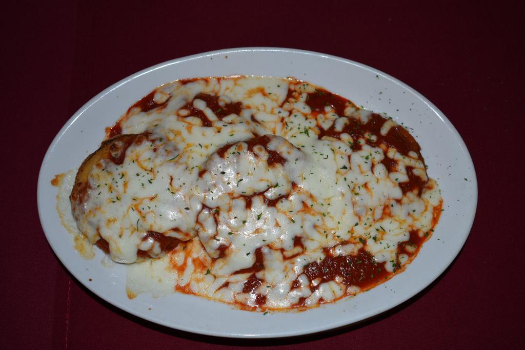 Eggplant a la Parmigiana · Freshly sliced egg plant, lightly breaded, fried and topped with meat or marinara sauce and baked with mozzarella cheese. Served with side spaghetti, side salad and bread.