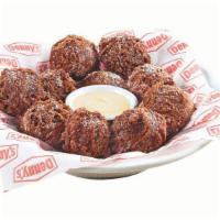 Double Chocolate Pancake Puppies® · Made with Ghirardelli® cocoa and chocolate chips, tossed in powered sugar and served with cr...