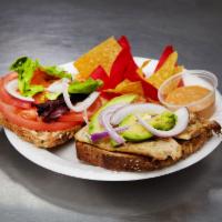 Grilled Chicken Sandwich · With avocado, tomato, red onions, mixed greens, and chipotle sauce. On 7-grain bread.