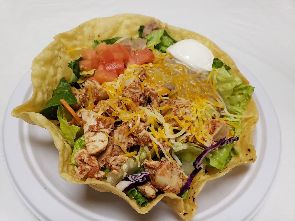 Taco Salad · Crispy tortilla shell with mixed greens, pinto beans, tomatoes, seasoned beef or chicken, sour cream, and shredded cheese. Guacamole upon request.