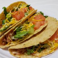 Taco · Soft or crispy, choice of taco meat or chicken, lettuce, tomatoes, and cheese.