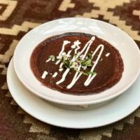 Black Bean Soup · a black bean purée topped with crema fresca, chopped red onions and cilantro
