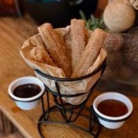 Churros · fried Mexican dough with cinnamon and sugar served with sweet milk and chocolate dipping sau...