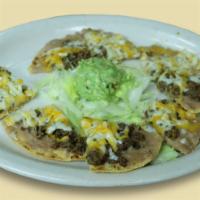 Fajita Nachos · 2 corn tortilla topped with your choice of chicken or beef fajita refried beans and cheddar ...