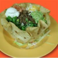 Taco Salad · Choice of ground beef or shredded chicken, mixed greens, tomatoes, red onion, cheese and gua...