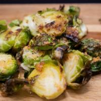 Brussel Sprouts · Super crispy, over baked brussel sprouts tossed in garlic butter and parmesan cheese.