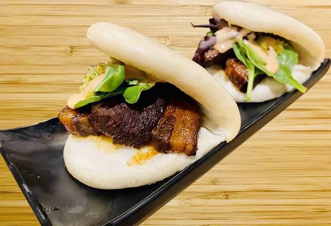 Pork Buns 2 Pieces · Slow cooked pork belly with bao bun, inside with spring mixed veggie.