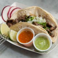 Carne Asada Taco · Grilled steak. Served with onion, cilantro, green sauce and red sauce on the side.
