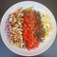 Cobb Salad · Bacon, red onions, tomatoes, blue cheese, red peppers, hard boiled eggs and grilled chicken.