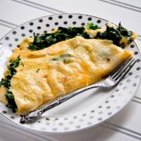 GREEK OMELETTE · Any style eggs, feta cheese, tomatoes and spinach 
