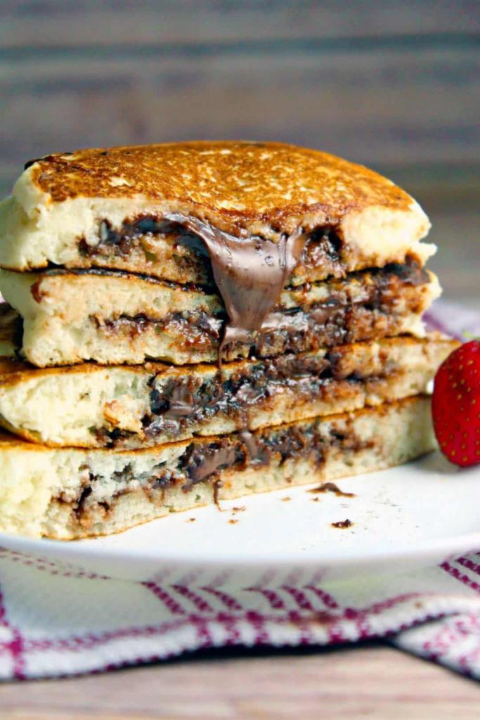 NUTELLA PANCAKES · Golden round pancakes topped with Nutella