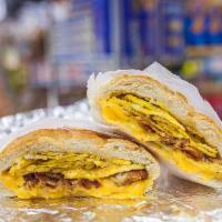 BACON OR SAUSAGE, EGGS AND CHEESE ON A ROLL · 