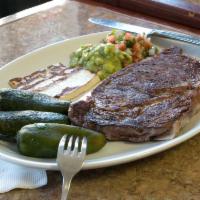 Bistec Poblano · Grilled rib eye steak, guacamole, pico de gallo, queso blanco and grilled jalapeno peppers. ...