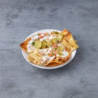 Regular Nachos · Tortilla chips, refried beans, melted cheese, pico de gallo, sour cream, and jalepenos.