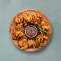 Onion Pakoras · Finely sliced onion rings dusted with our house special seasoning and batter fried crisp and...