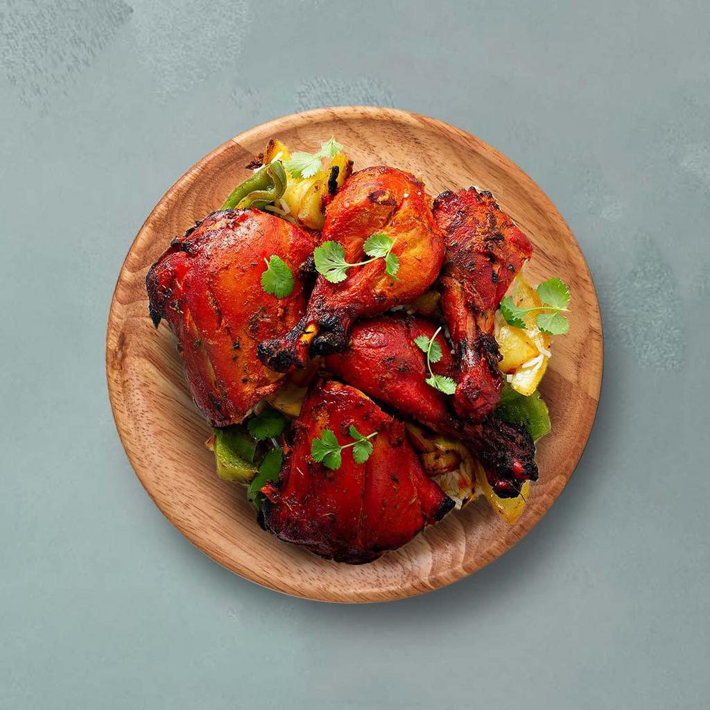 Old Delhi Chicken Tandoori · Bone-in spring chicken seasoned with tandoori marinade, skewered and chargrilled in a clay tandoor oven. Served with a refreshing mint sauce. 