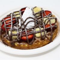 Nutella Waffle · Nutella drizzled over a waffle topped with whipped cream and powdered sugar.