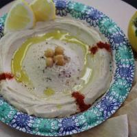 Hummus Bowl · Bowl of homemade Lebanese hummus with pita bread on the side.