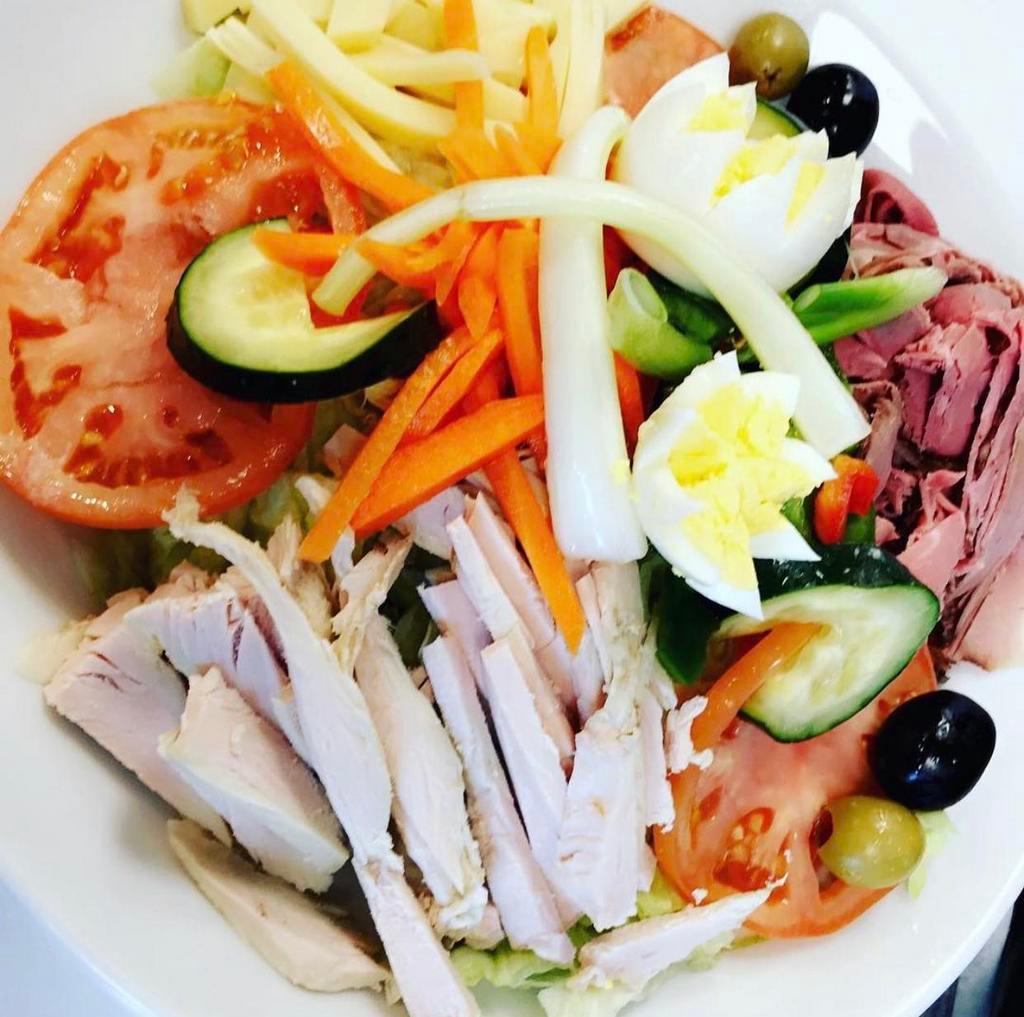 Chef Salad · Turkey, roast beef, Switzerland Swiss cheese, hard-boiled eggs, tomatoes, cucumbers, peppers, olives, radishes, carrots, scallions, celery and iceberg lettuce.