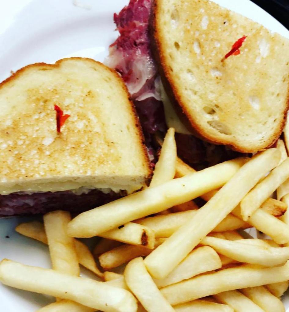 Grilled Reuben Sandwich · Served with french fries and coleslaw. 