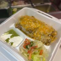 Pork Green Chili Smothered Burrito · Smothered flour tortilla filled with green chilli, cheese, rice and beans. Topped with green...