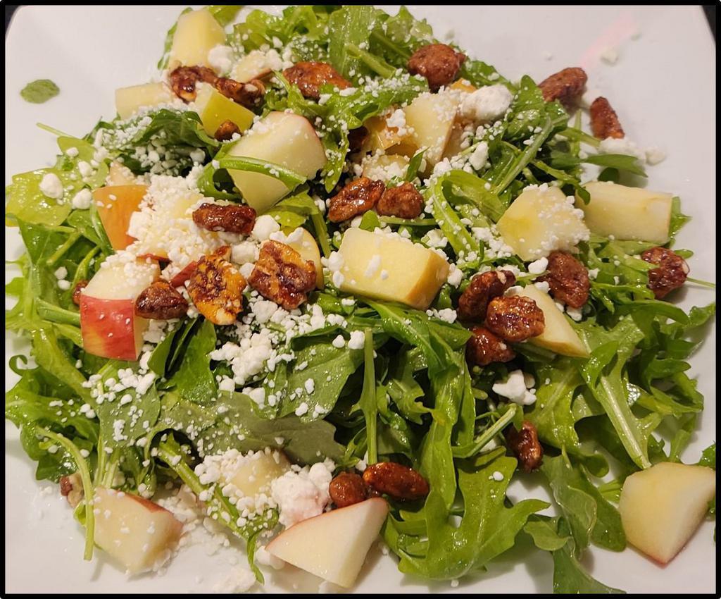 Honey Apple Arugula Salad · Crisp diced apples, candied pecans and goat cheese crumbles over baby arugula tossed with house made honey ginger vinaigrette dressing
