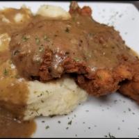 Country Fried Chicken · Lightly dusted Buttermilk chicken breast deep fried to a crisp over garlic mashed potatoes t...