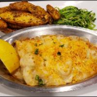 New England Baked Cod · Fresh Atlantic Cod baked in white wine, topped with our house New England Style Chowder & ol...