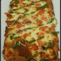 Margherita Flatbread · Topped with mozzarella, diced tomatoes and a basil pesto drizzle
