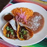 Street Taco Plate · 2 tacos served on our house corn tortillas, served with tomato rice, refried beans, Cotija c...