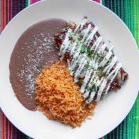 Enchiladas Rojas · Stuffed rolled corn tortillas covered in our house mole, served with tomato rice, refried be...