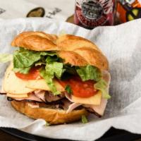 The Hampton Sandwich · Boar's Head brand honey maple coated turkey with chipotle gouda on a toasted croissant dress...
