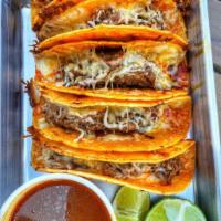 Birria Taco · Shredded beef, melted Monterey cheese, onions, cilantro. Extra cheese is available for an ad...