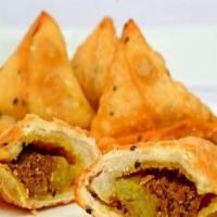 Chicken Samosa · Two crisp turnovers, stuffed with mildly spiced ground chicken and garden peas.