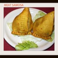 Meat Samosa · Two crisp turnovers stuffed with mildly spiced ground lamb and garden peas.