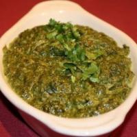 Saag Paneer · Cubes of cottage cheese simmered in pureed spinach with ginger garlic and spices.