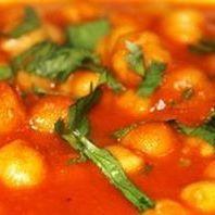 Chana Masala · Garbanzo beans cooked with fresh tomatoes, onions and spices in a flavorful sauce.