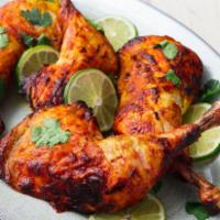 Tandoori Chicken · Chicken marinated in tandoori masala and yogurt for 24 hours, then barbecued to perfection i...